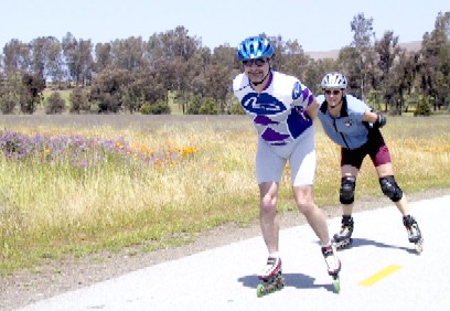 Two skaters reducing wind resistance